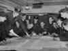 A group of sergeants being briefed in an ops. room.