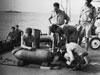Fuzing a bomb on board an aircraft carrier. This is where the ground crews would also have been trained to do this on carriers.