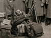 In the kit are canteens, blankets, K98 rifles, haversacks and many brown paper, tied with string, parcels.