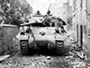 An M10 crawling through a French village.