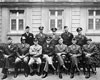 American generals: seated left to right are William H. Simpson, George S. Patton, Jr., Carl Spaatz, Dwight D. Eisenhower, Omar Bradley, Courtney H. Hodges, and Leonard T. Gerow; standing are Ralph F. Stearley, Hoyt S. Vandenberg, Walter Bedell Smith, Otto P. Weyland, and Richard E. Nugent