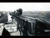 Workmen up on the rails.