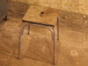 Metal stool with a wooden seat.
