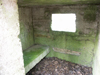 Inside with a concrete bench to sit on? or is it for spare ammunition.