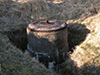 Gun mounting set into the ground not in an emplacement.