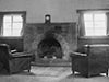Officers Mess fire place and two leather armchairs.