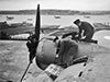 Erks working on one of the engines. Parts of the Sunderland's wing folded to make a safe place to stand.