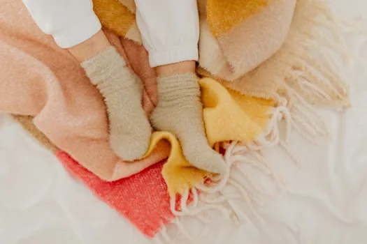 Warm fluffy socks on a blanket
