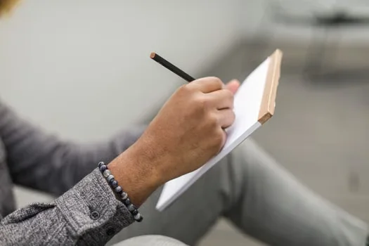Writing thoughts on a note pad