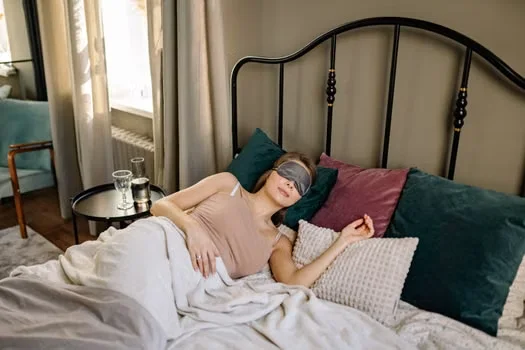 Woman resting in bed during daytime