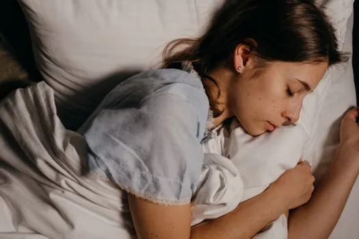 Young woman sleeping in bed