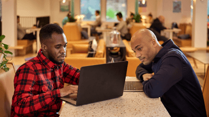 Wilfrid and Christian looking at the laptop screen