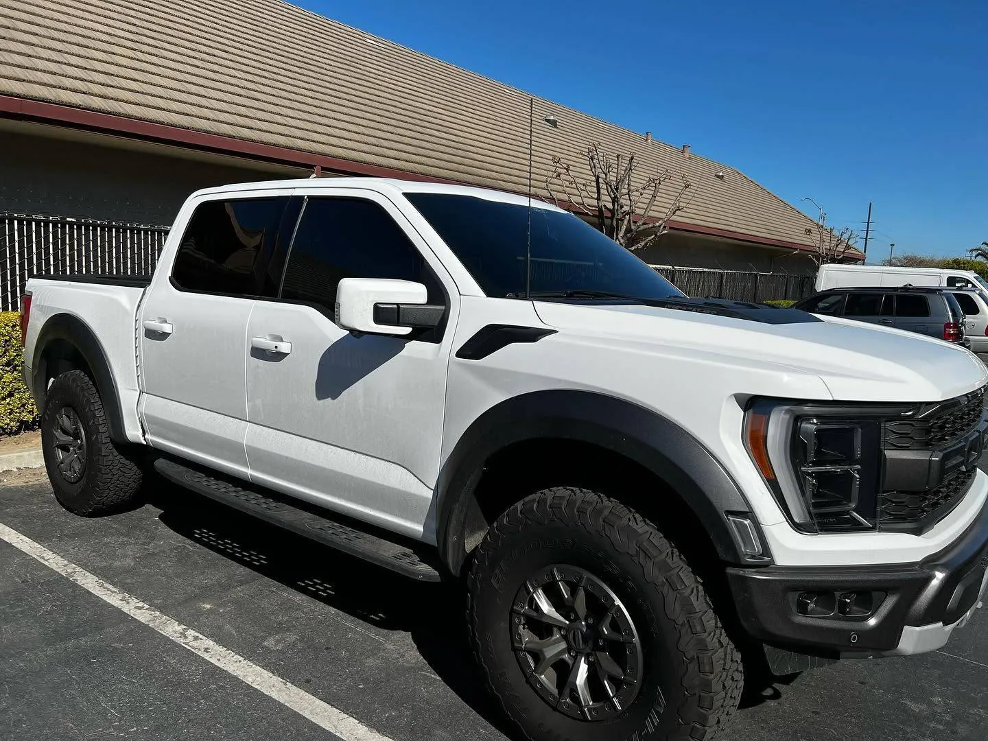 White Ford F-150 Raptor with tinted windows