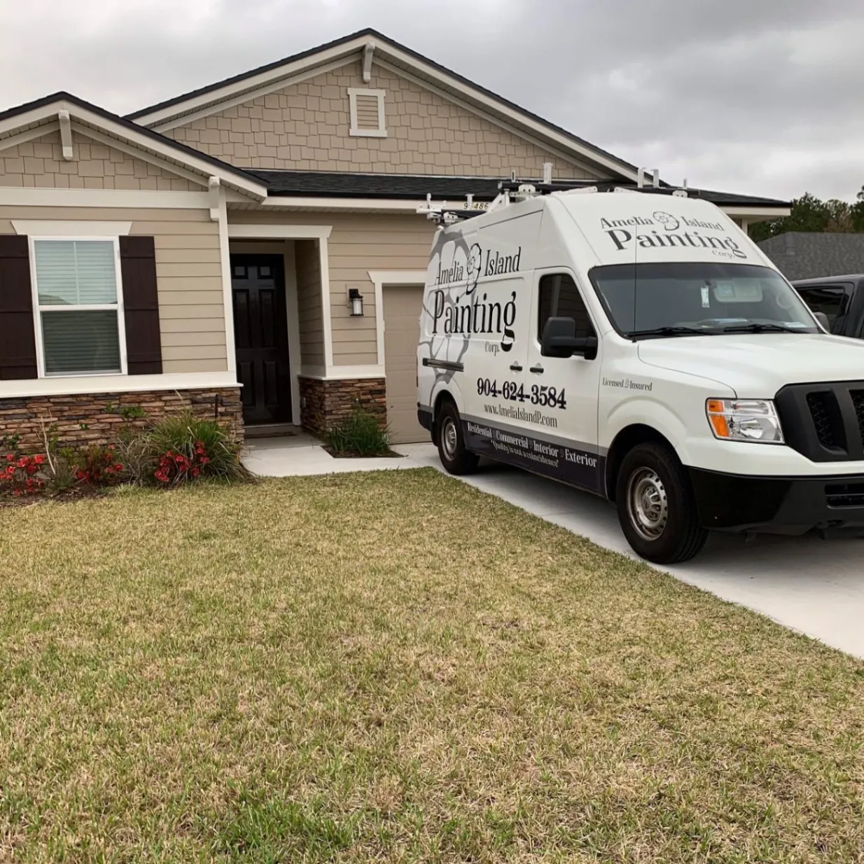 Newer craftsman-style home with tan siding and stone base after an exterior paint job