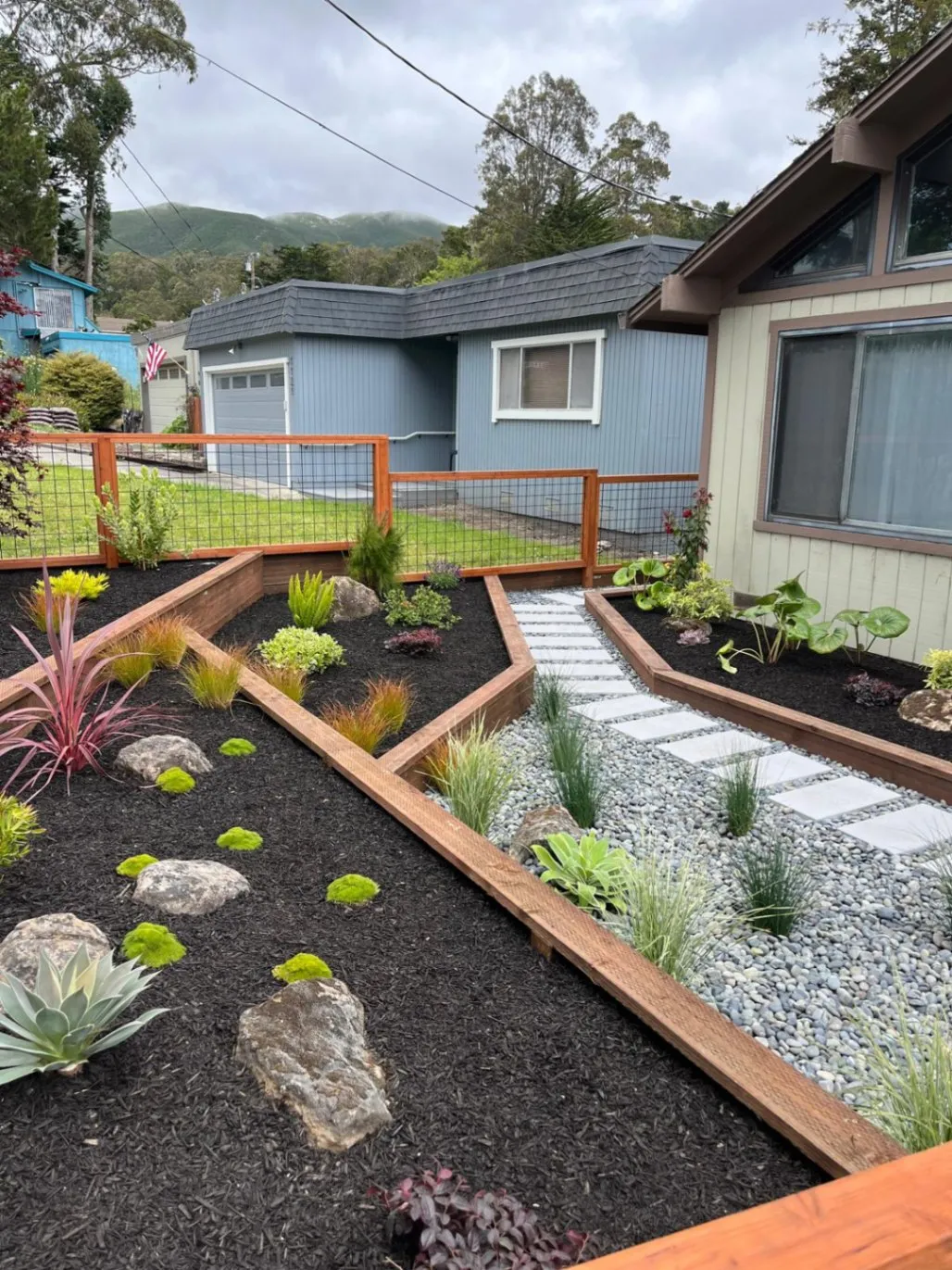 Front garden walkway with paver landing between redwood-framed planting beds