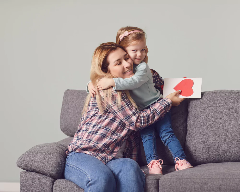  heartwarming image of a parent reading a Valentine’s card with their child.