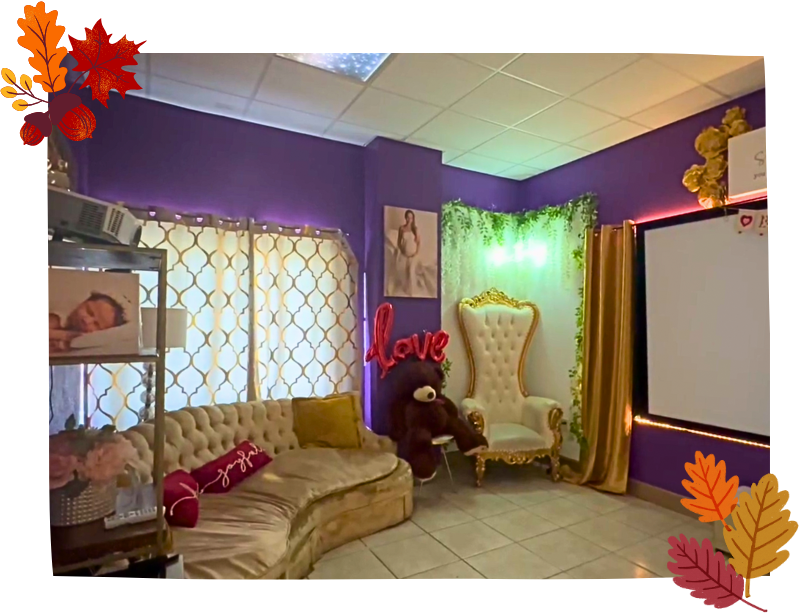 Baby Fairytale ultrasound viewing area featuring a cozy couch and projector screen for families to watch 3D/4D ultrasound sessions together.