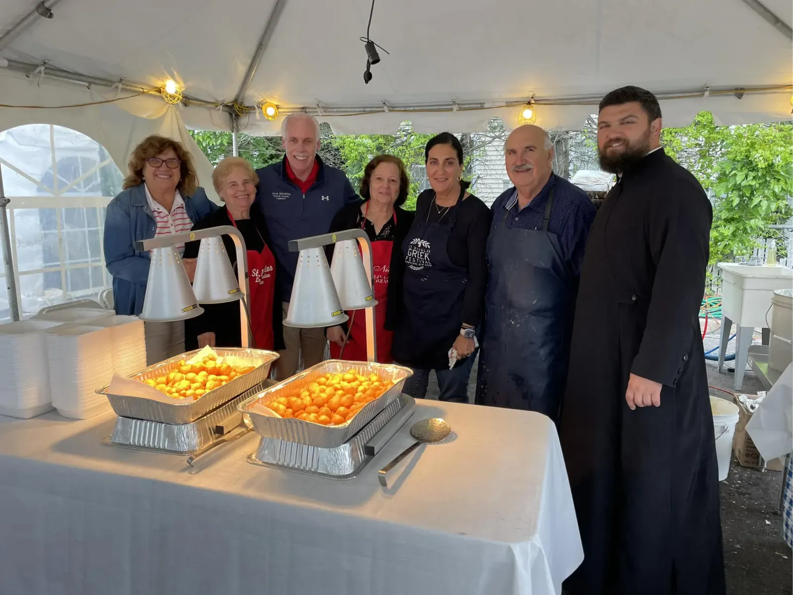 Trays of fresh loukoumades with the loukoumades team