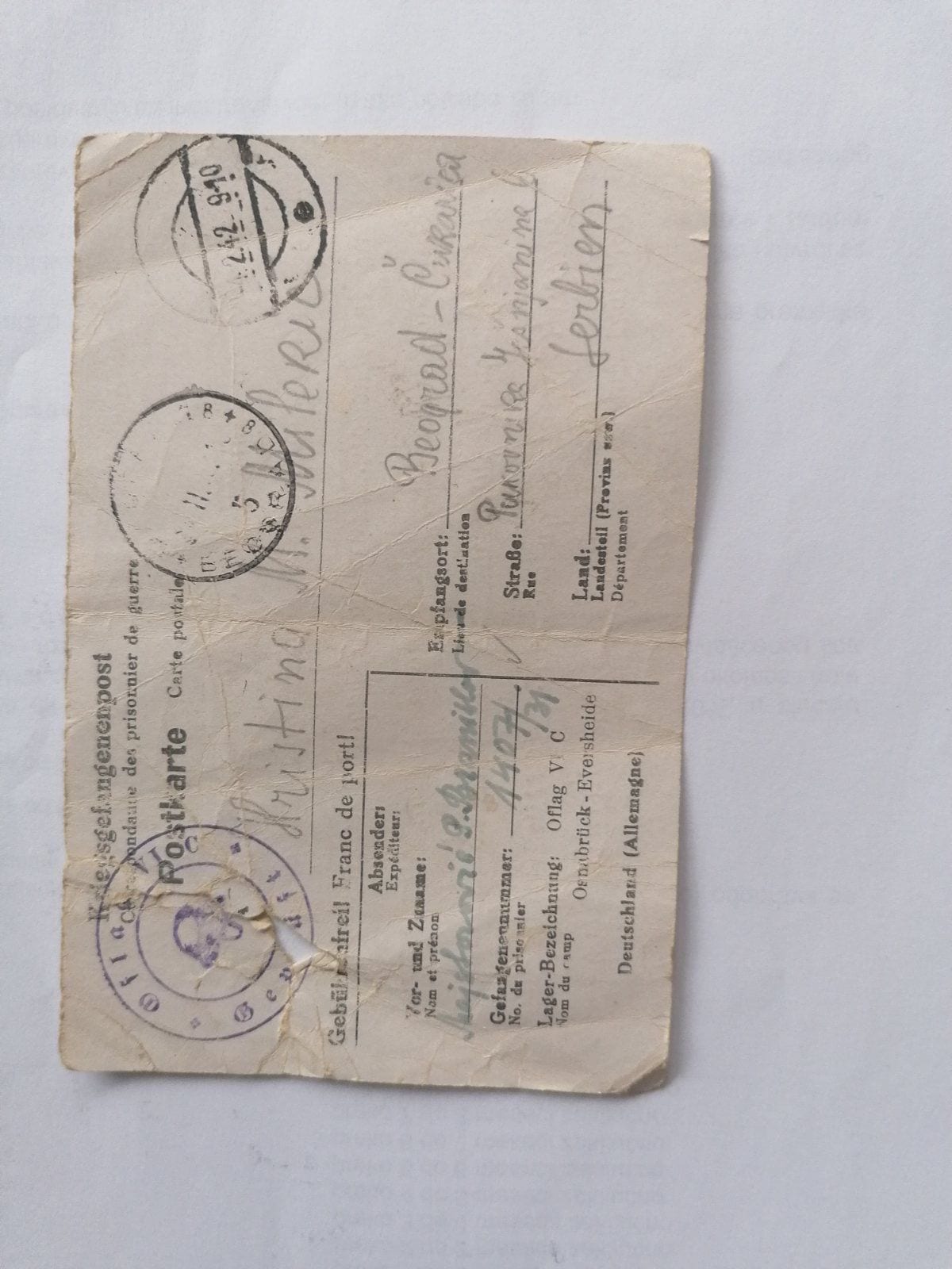 Адресна страна сачуване заробљеничке дописнице из логора Офлаг VI Ц Оснабрик-Еверсхајде, упућене породици у Београд, са печатом логорске цензуре
