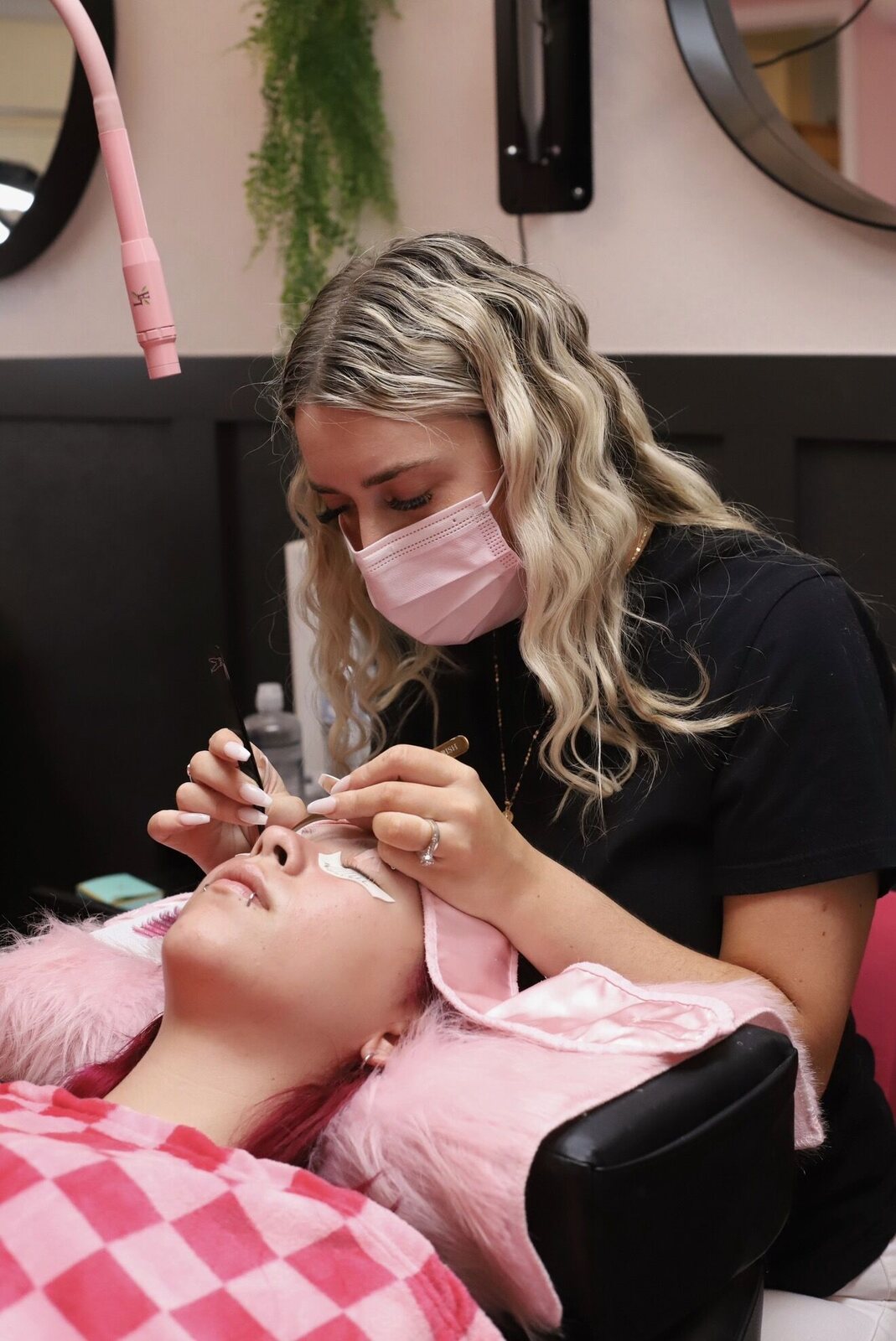 Cortney applying lash extensions