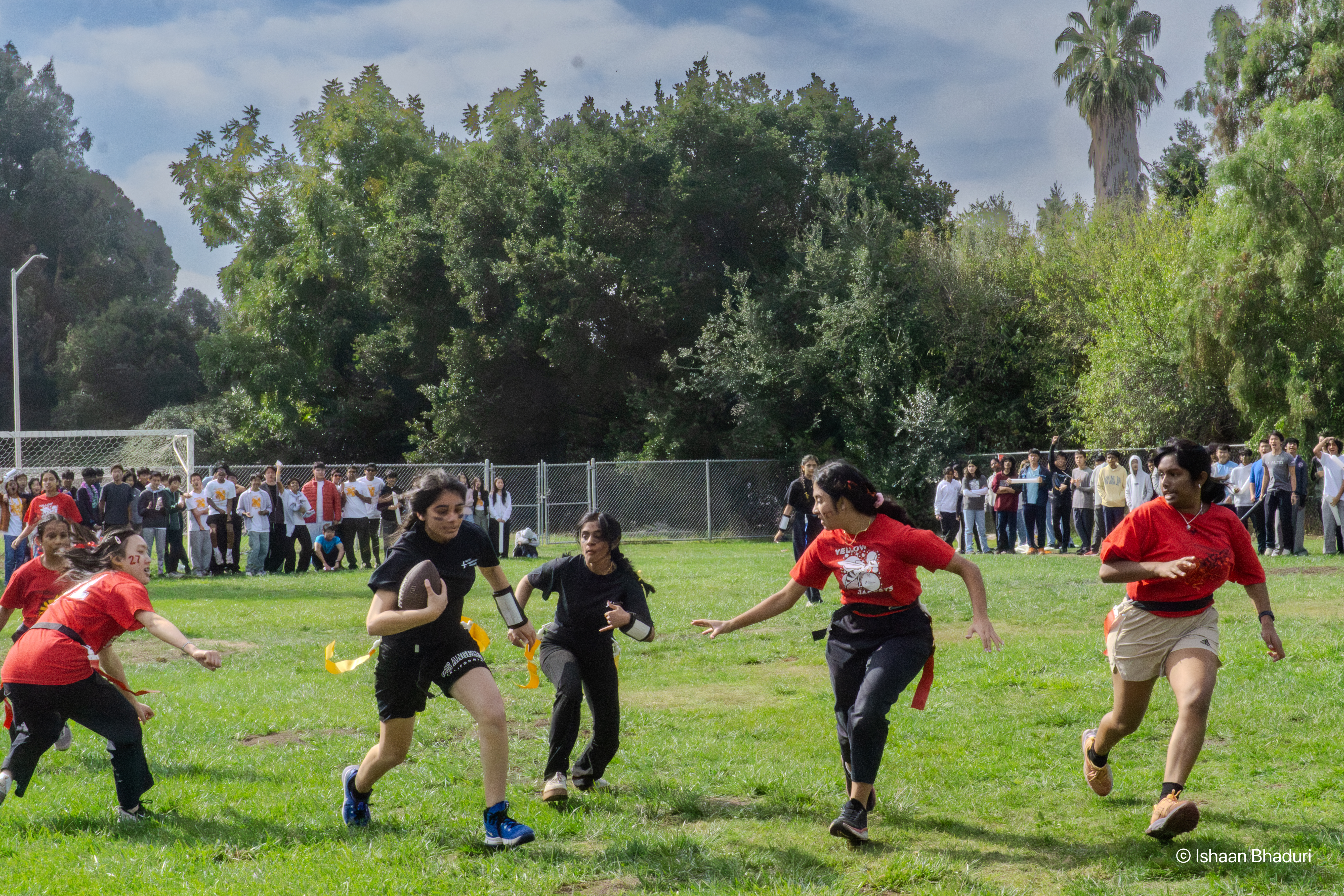 Diva Shah (12) runs with the ball at the Homecoming football game.