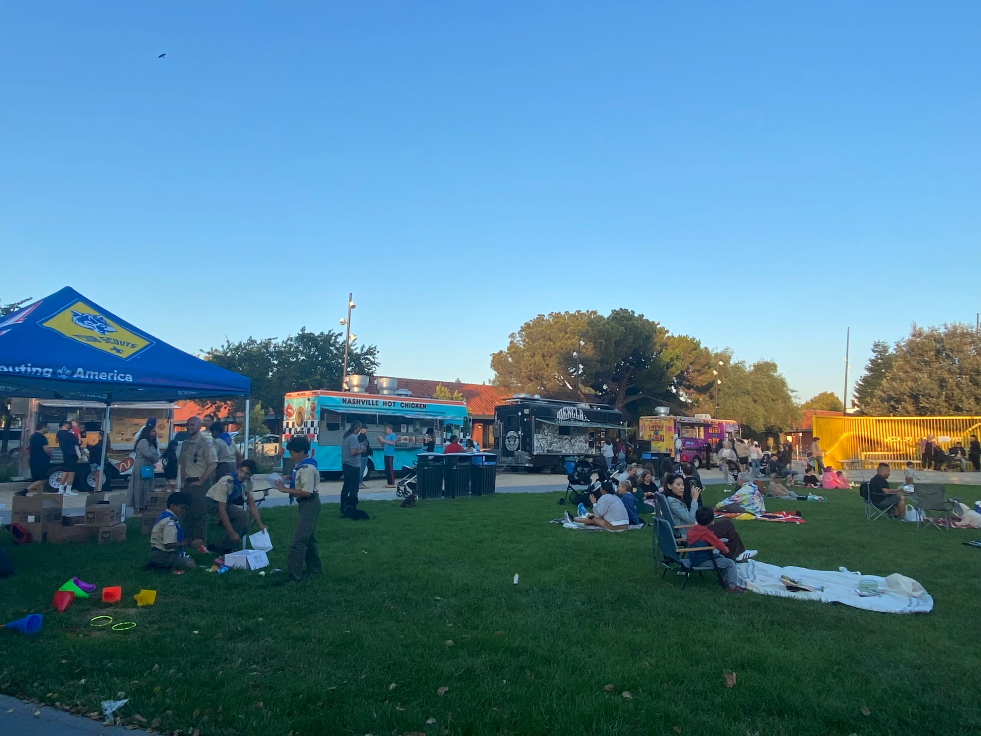 Families relax on picnic blankets and enjoy dinner at Fremont Street Eats.