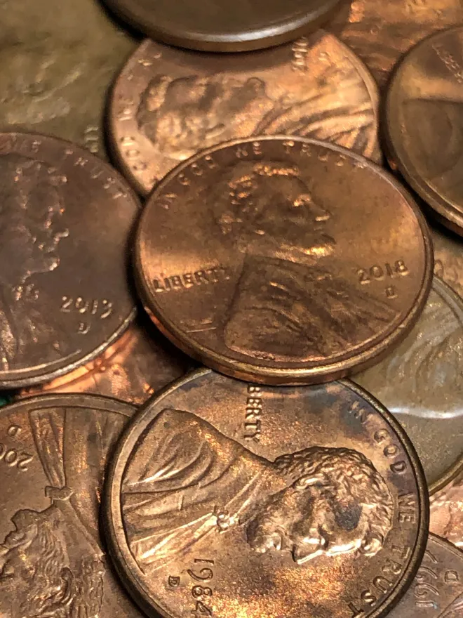 A close-up grouping of overlapping copper-colored pennies.