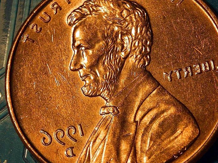 A close-up view of a copper-colored Lincoln penny.
