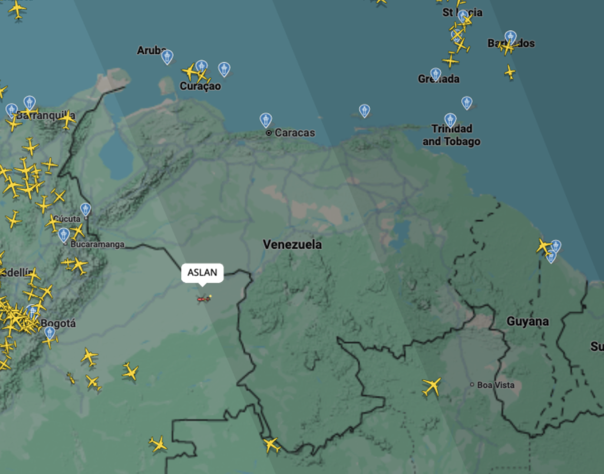 Flight-tracking map showing Venezuela and nearby Caribbean islands, with relatively few aircraft displayed over Venezuela and more aircraft visible around the surrounding region.