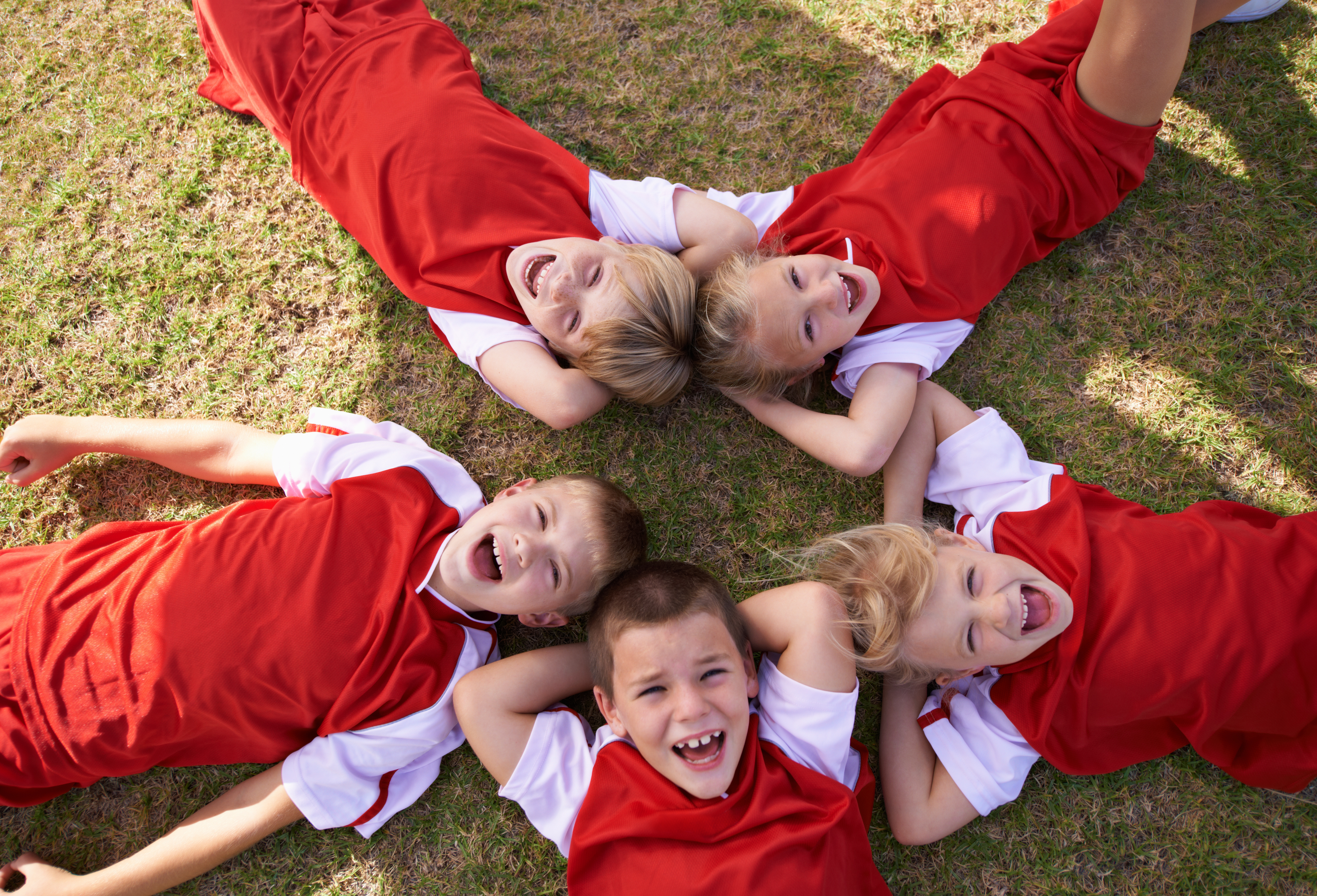 Kids laying on grass