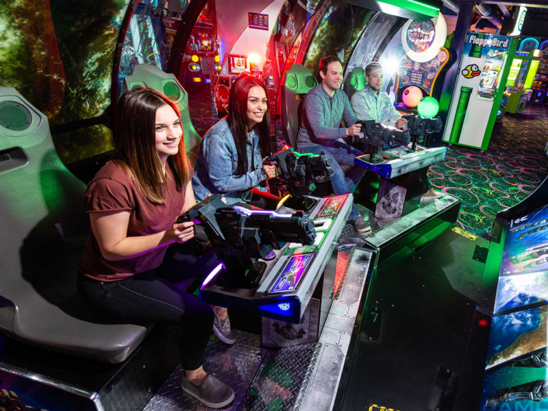 people playing arcade games