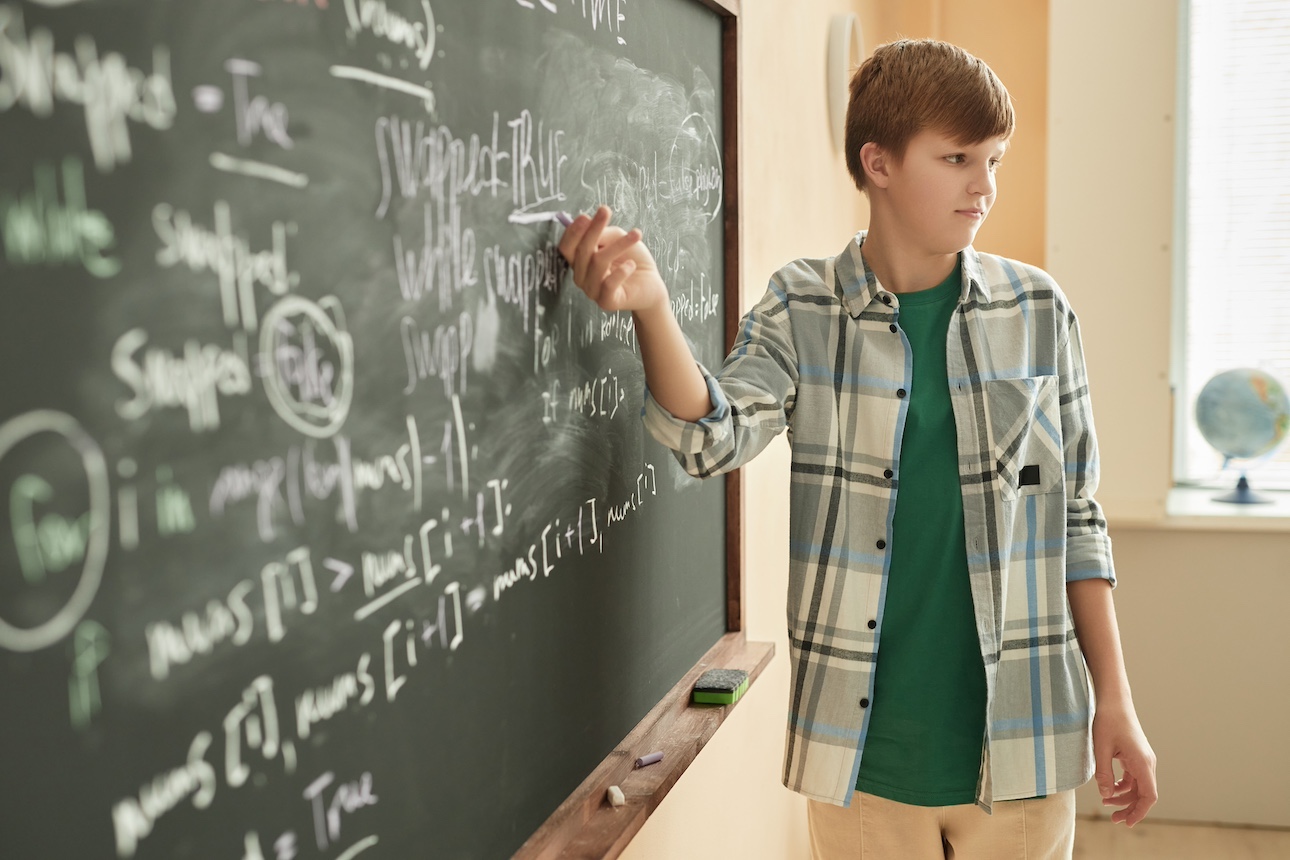 Kid at a chalkboard