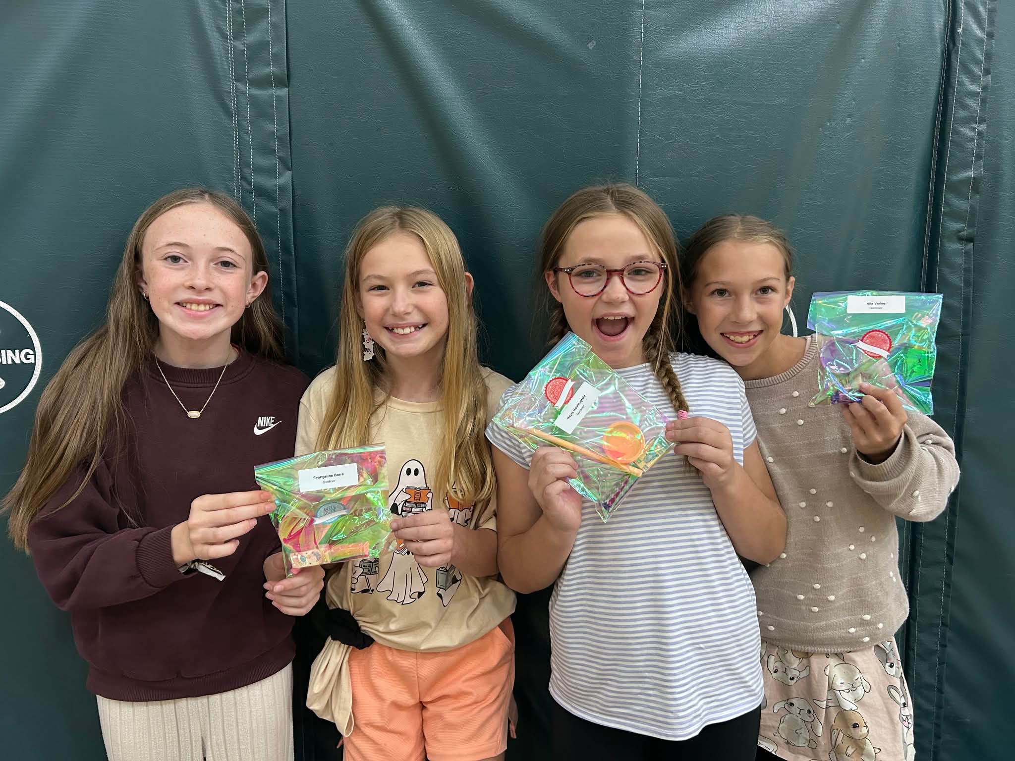Four students holding prizes
