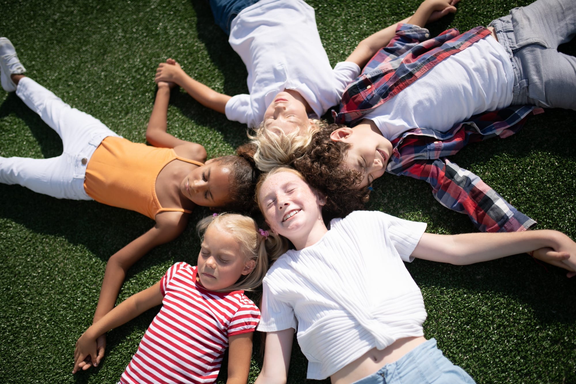 kids laying in the grass