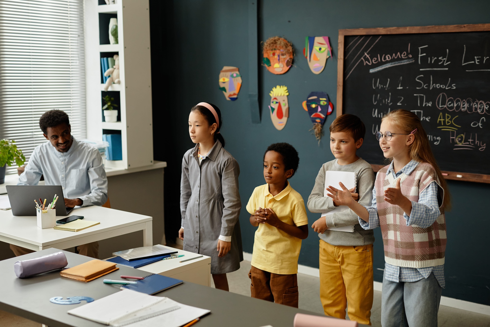 Kids standing at the front of a classroom