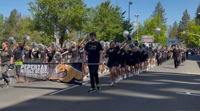 peperzak middle school drill team and marching band walking in parade