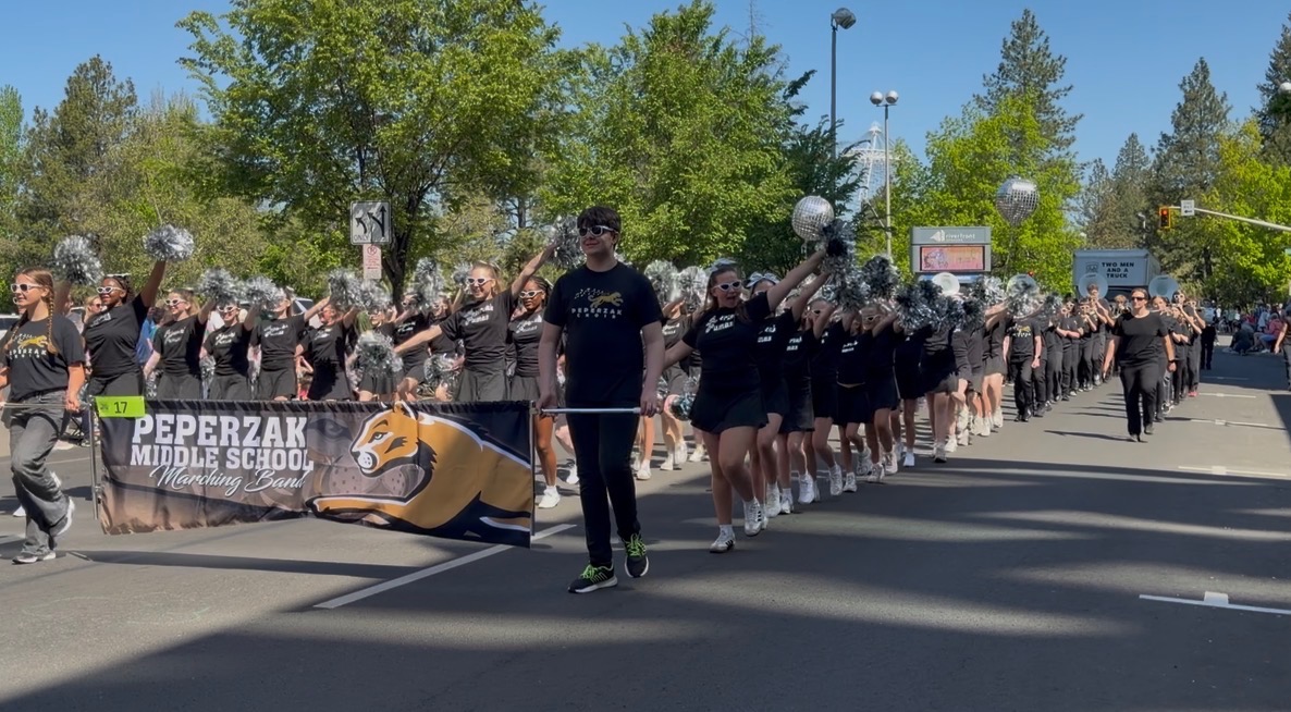 peperzak middle school drill team and marching band walking in parade