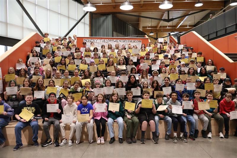 Students holding up certificates