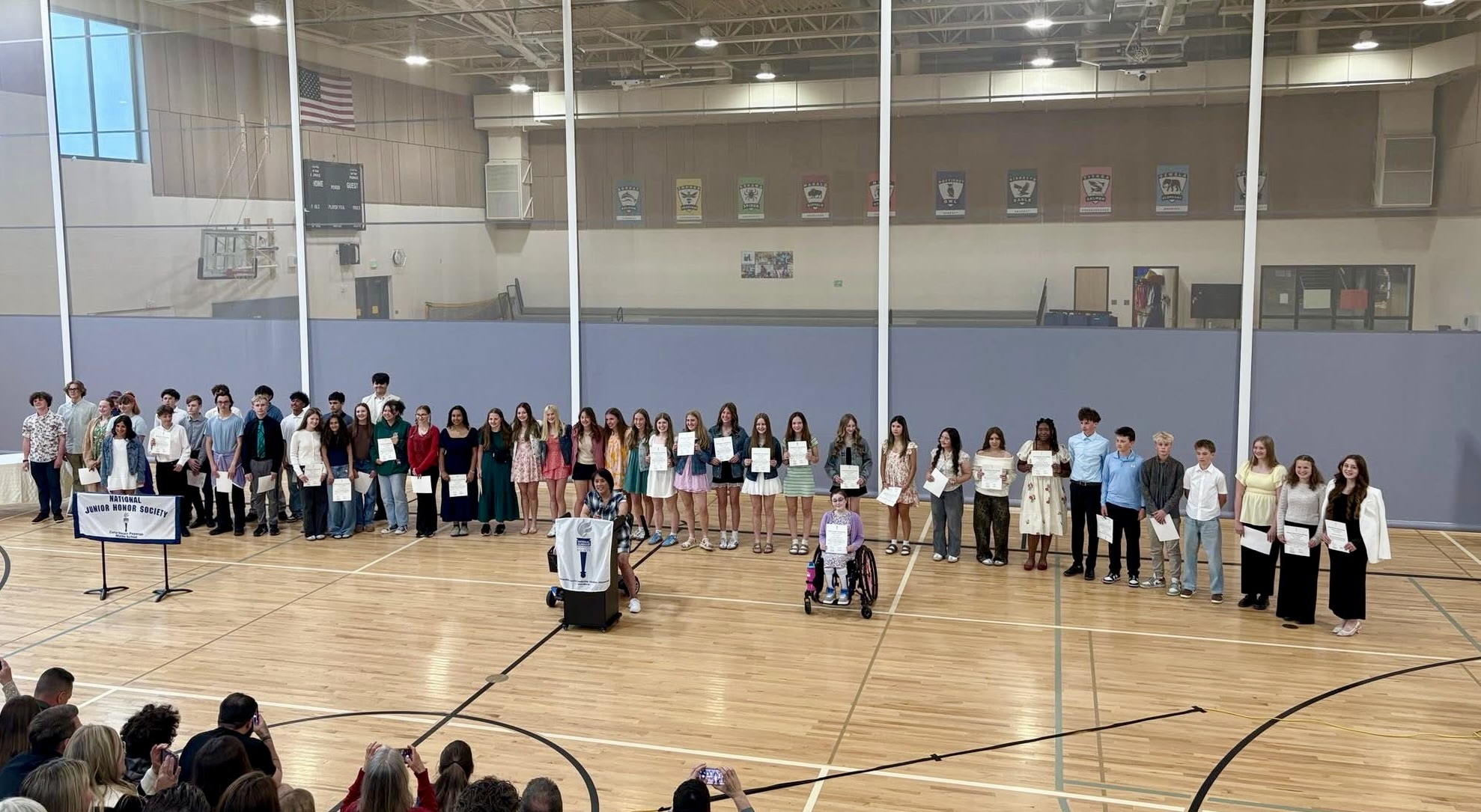 Students standing on gym floor