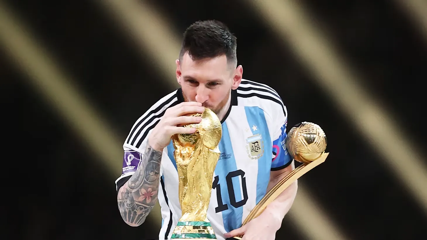 Messi kisses World Cup trophy during the awards ceremony on 18 December 2022
