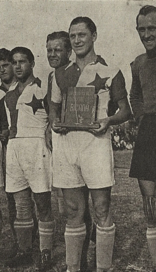 Bican, wearing Slavia Prague's star-crested shirt, receives a plaque marking his scoring feats, August 1938.
