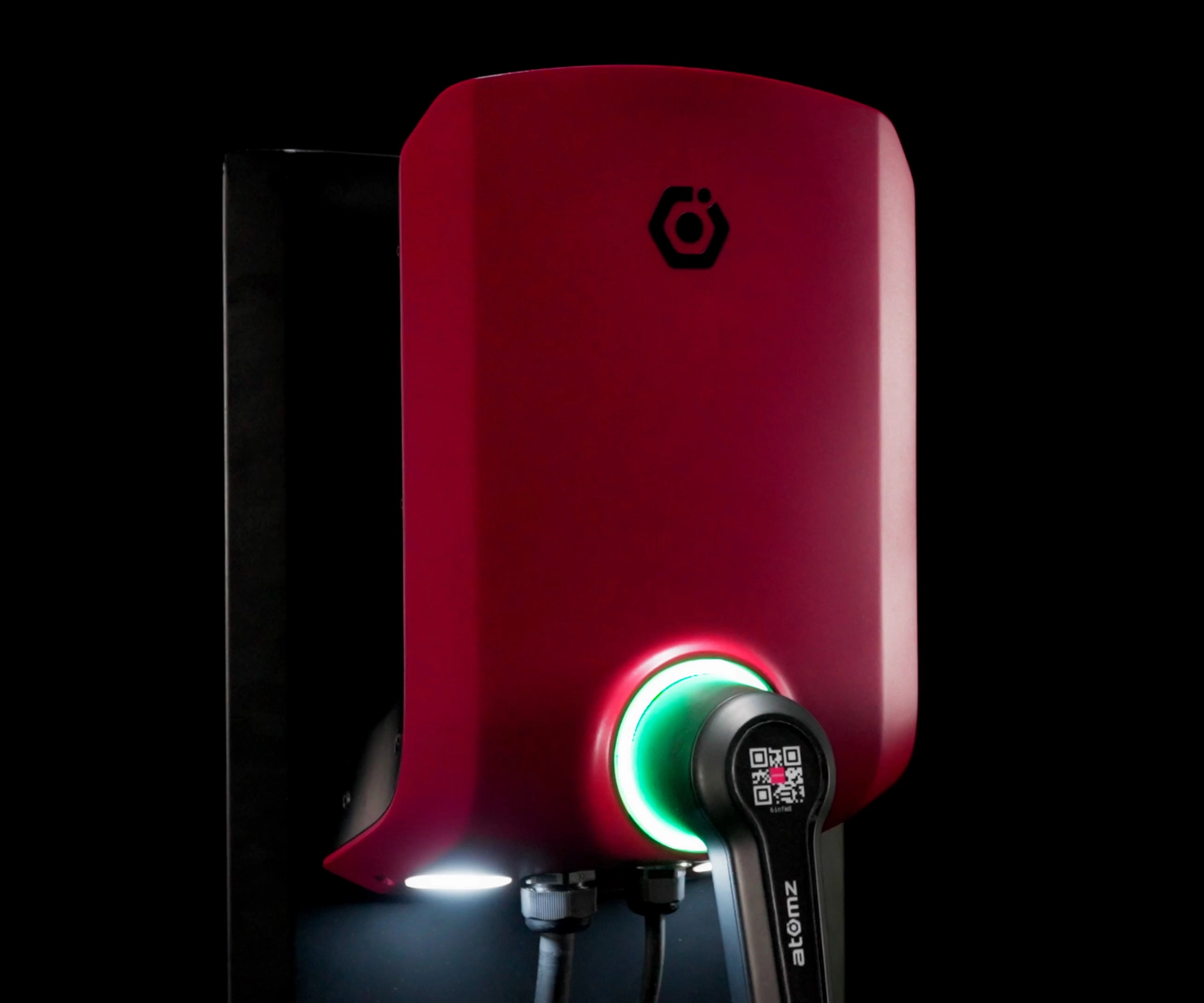 Image of a red EV charging unit shot against a black background with studio lighting, low key lighting highlight the subject, high quality image of the EV charger.