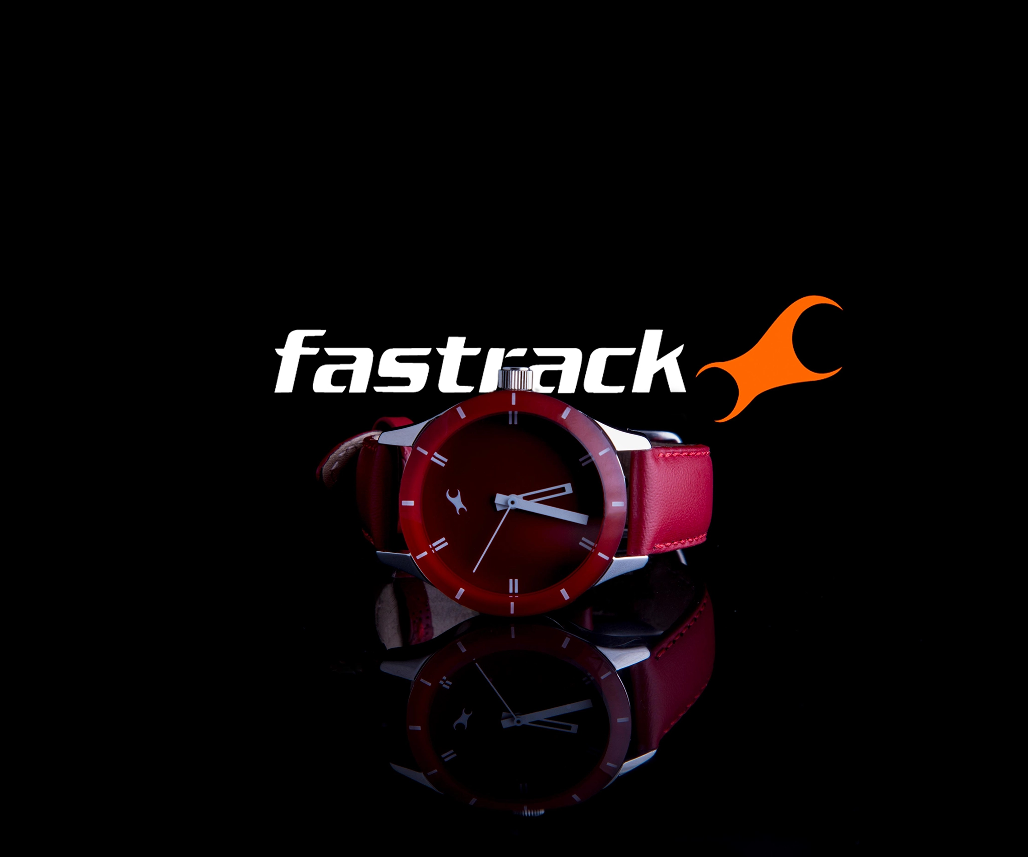 Image of a red fastrack watch kept on a black reflective surface, high end product photography of the product in focus