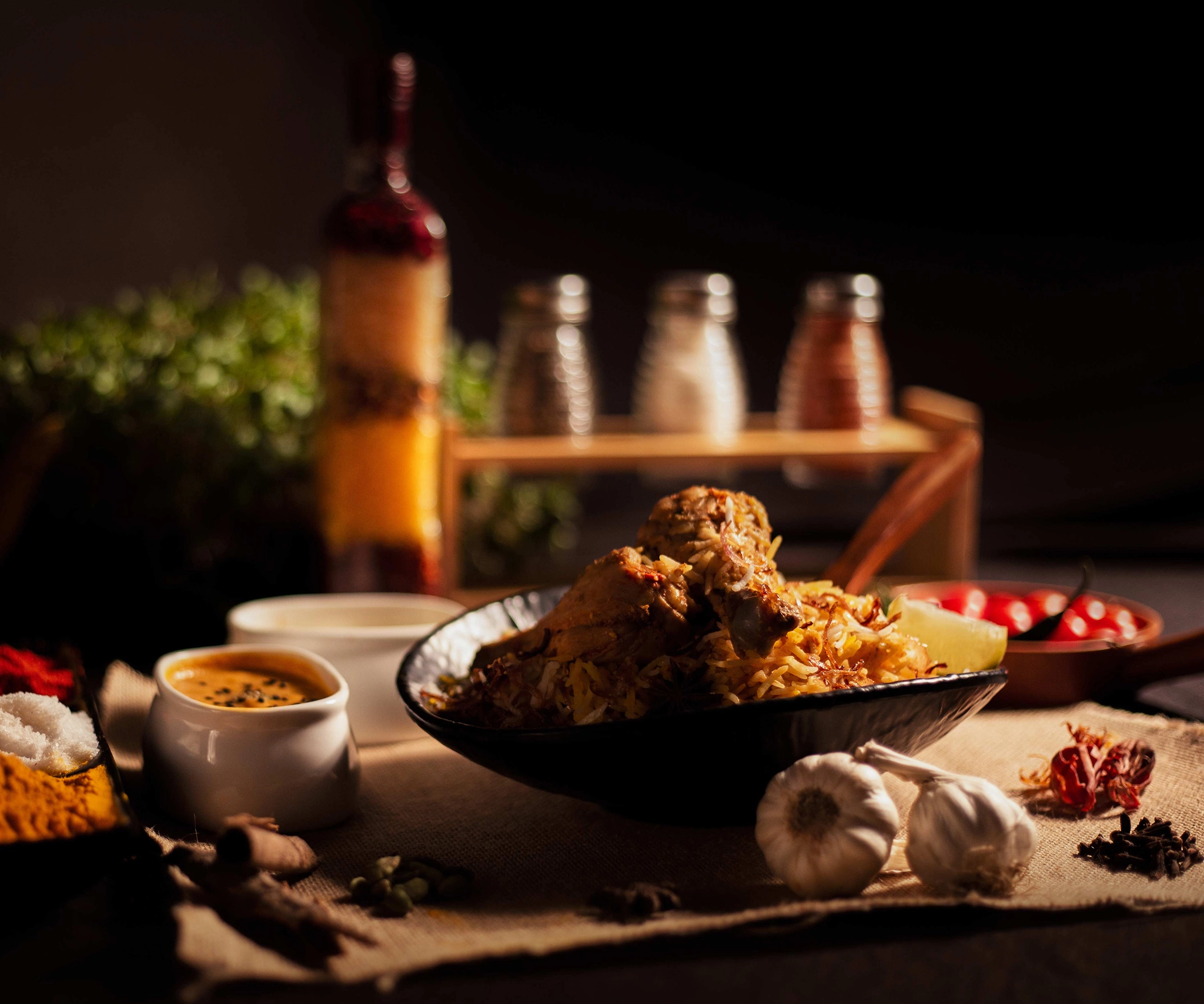 Image of a chicken biryani kept on a bowl and in a moody kitchen setup