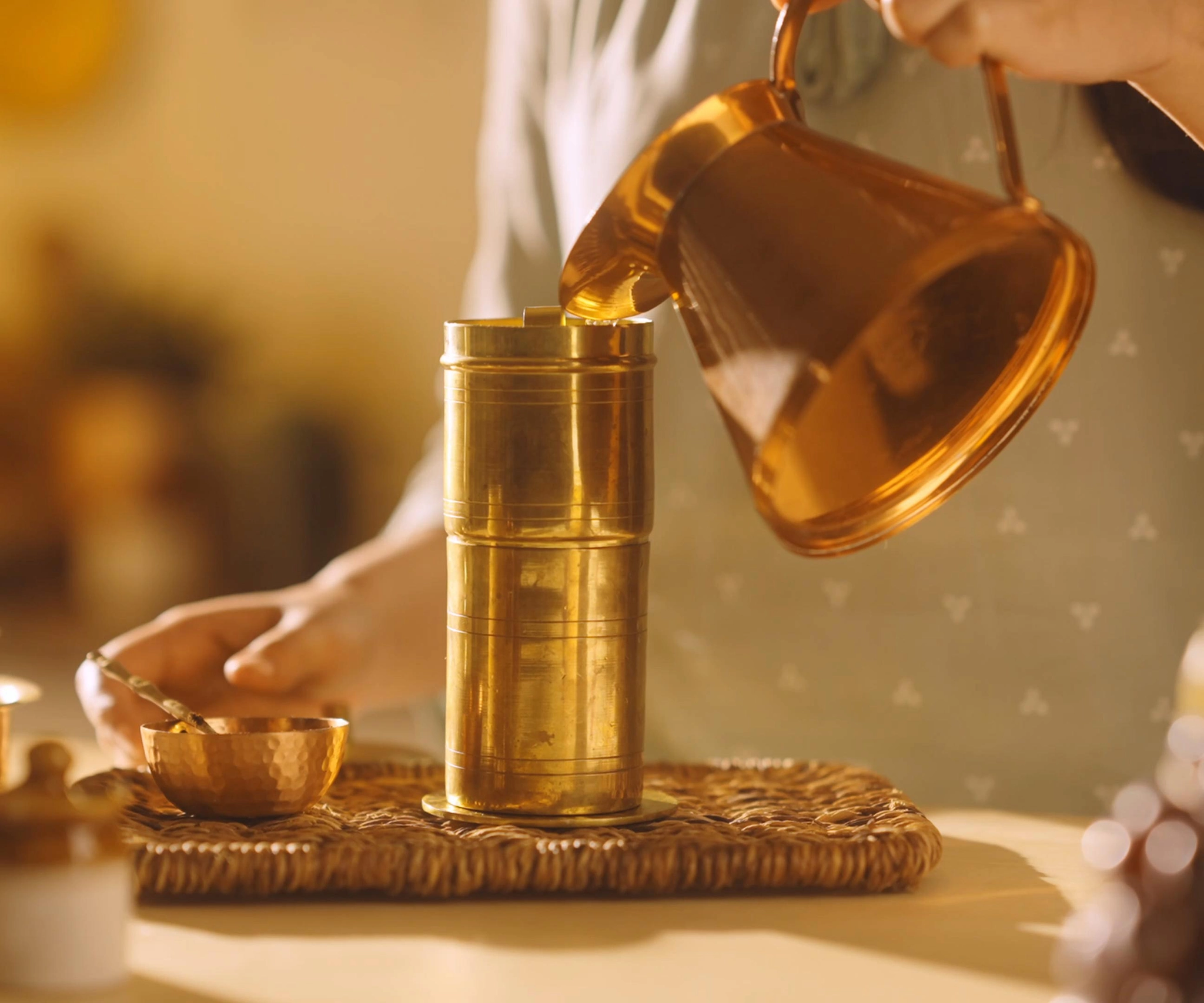 High quality photo of a girl pouring hot water on top of a filter coffee maker, copper tumbler with hot water poured on a coffee filter coffee maker. 