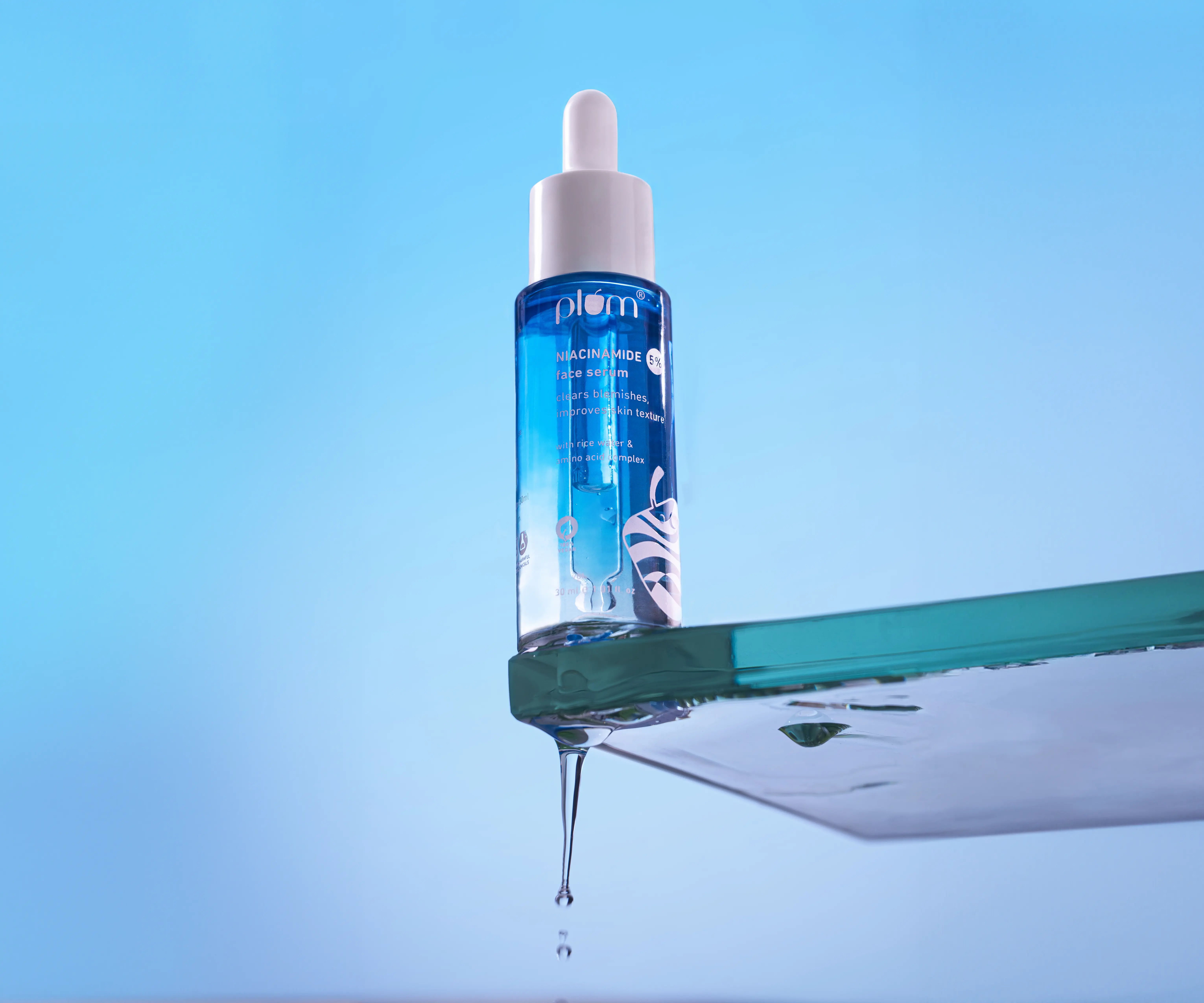 Product photography of skincare brand, the dropper of the serum squeezing product out of the dropper, bottle cap open shot of skincare product 