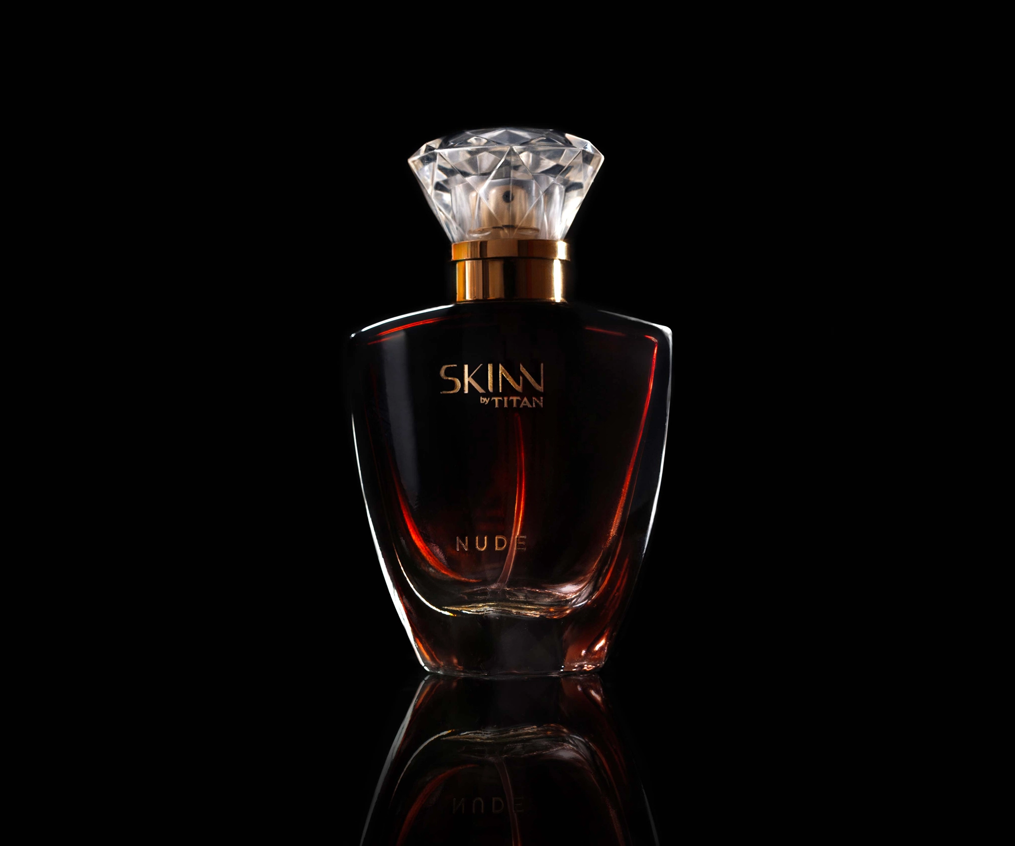 High quality product photography of skinn by titan on a black background, targeted low key lighting that shows the bottle and brand name
