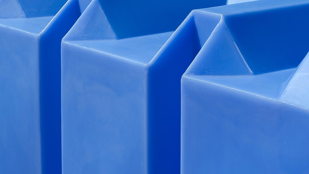Close-up of smooth blue moulded plastic containers with angled corners and seams.