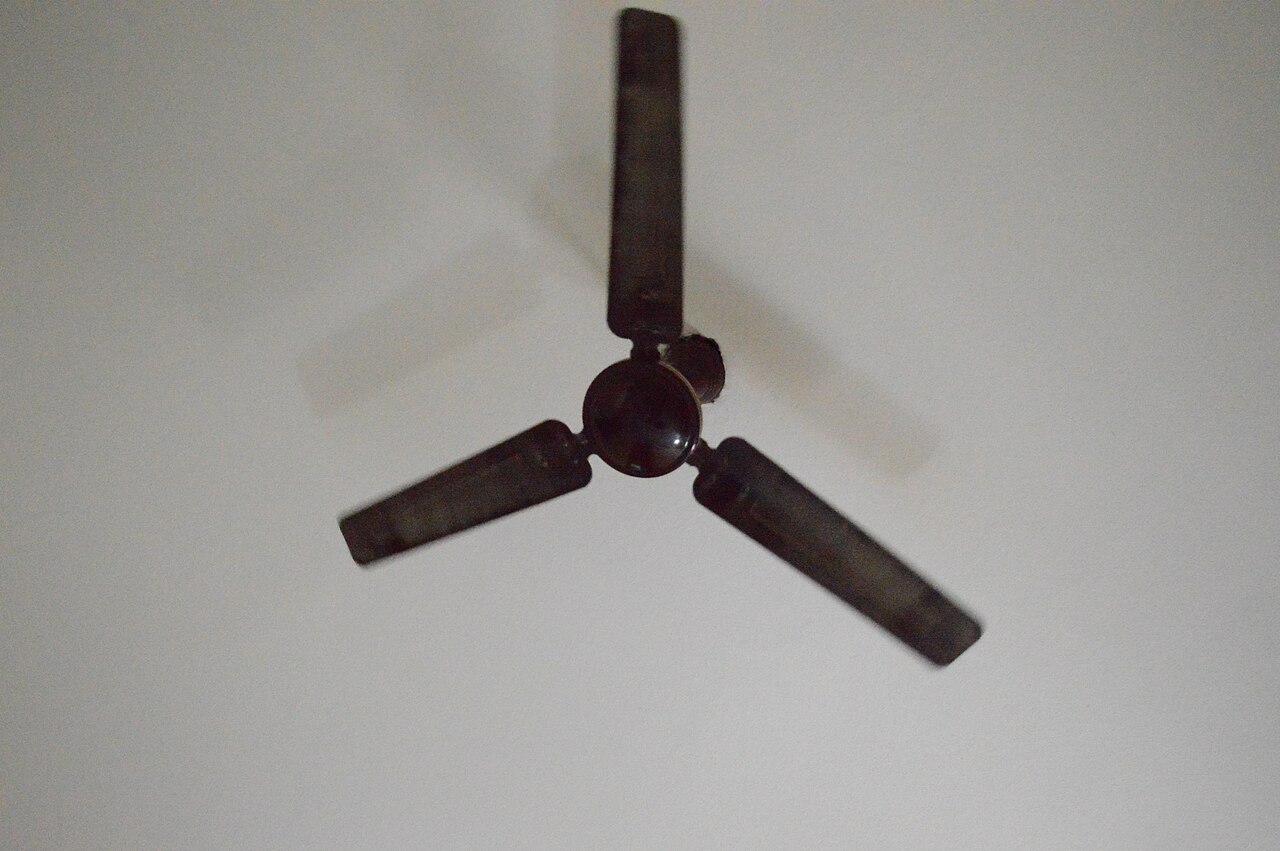 A ceiling fan mounted on a white ceiling