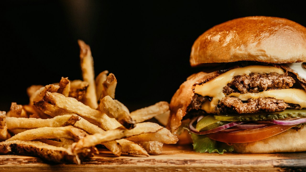 A burger served with fries.